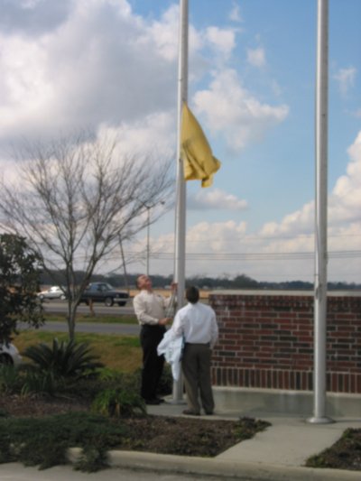 Taking down Brusly Centennial flag